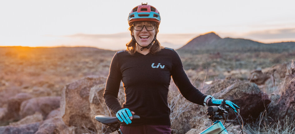Rebecca Rusch in rugged, arid terrain with her mountain bike