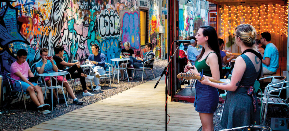 Female singers performing at a cozy outside bar