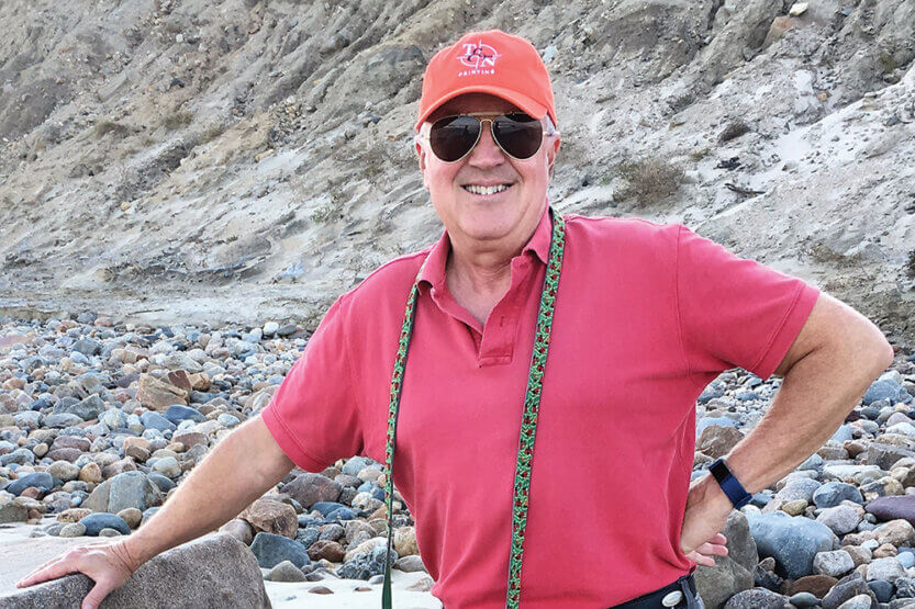 Doug Gilpin standing on a rocky beach