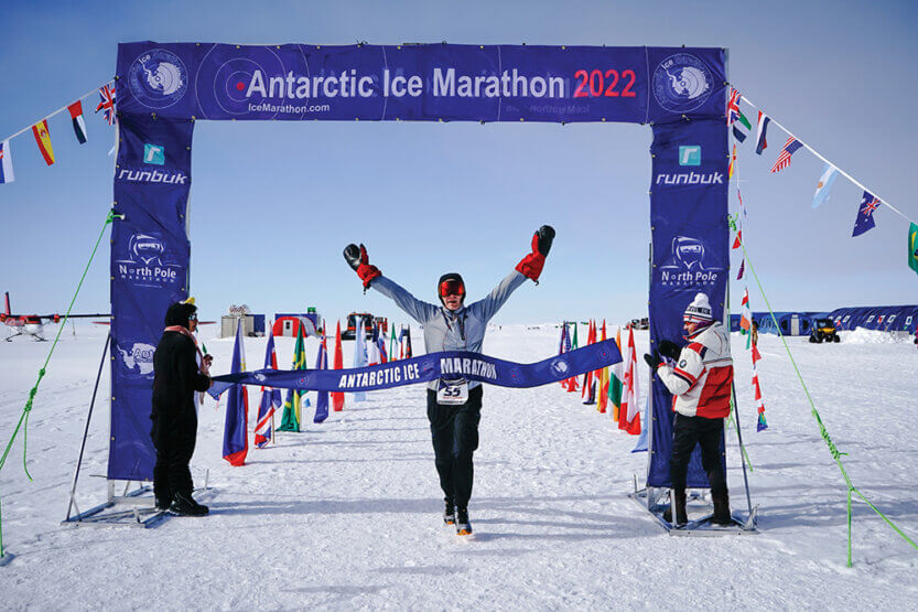 Scott Ziffra crossing the finish line at the 2022 Antarctic Ice Marathon.