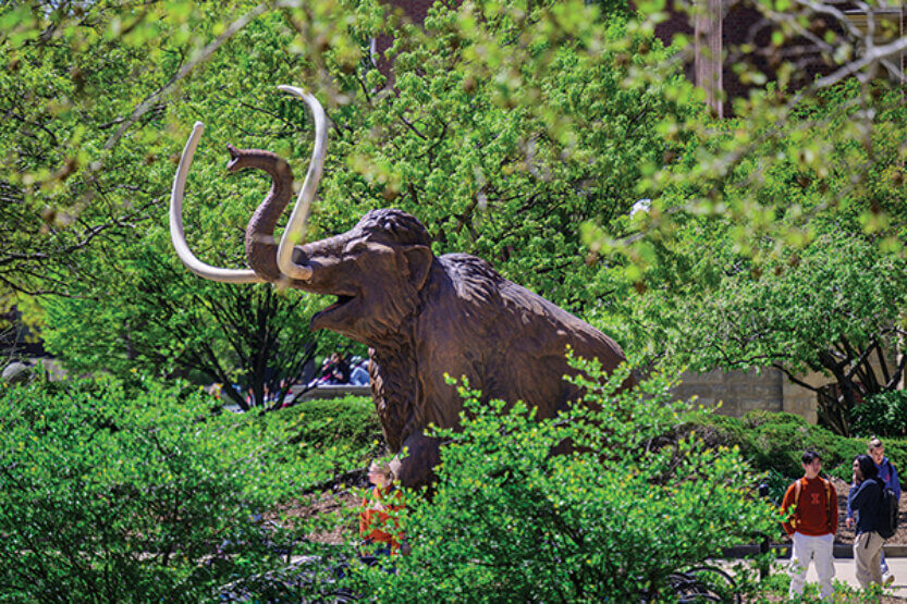 Students head to classes past the 12-foot-tall, 15-foot-long woolly mammoth sculpture.