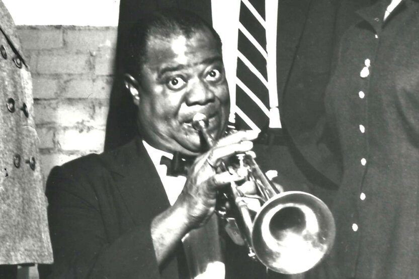 Louis Armstrong blowing a trumpet