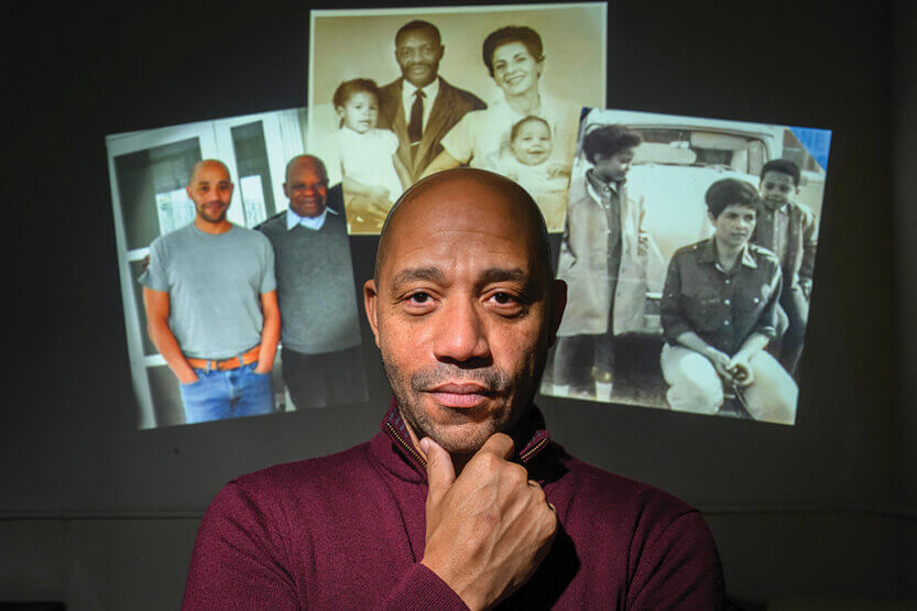 David Wright Faladé posed in front of images of his family