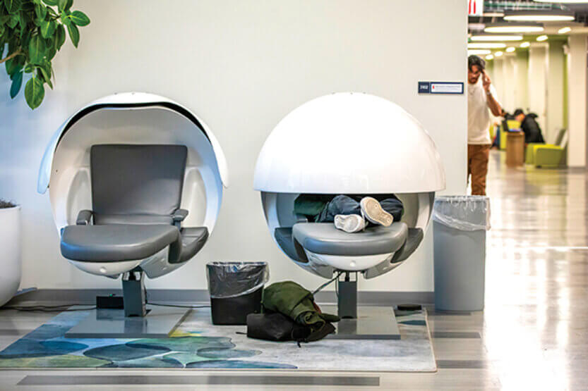Student studying for finals in a Nap Pod in the Sidney Lu Mechanical Engineering Building.