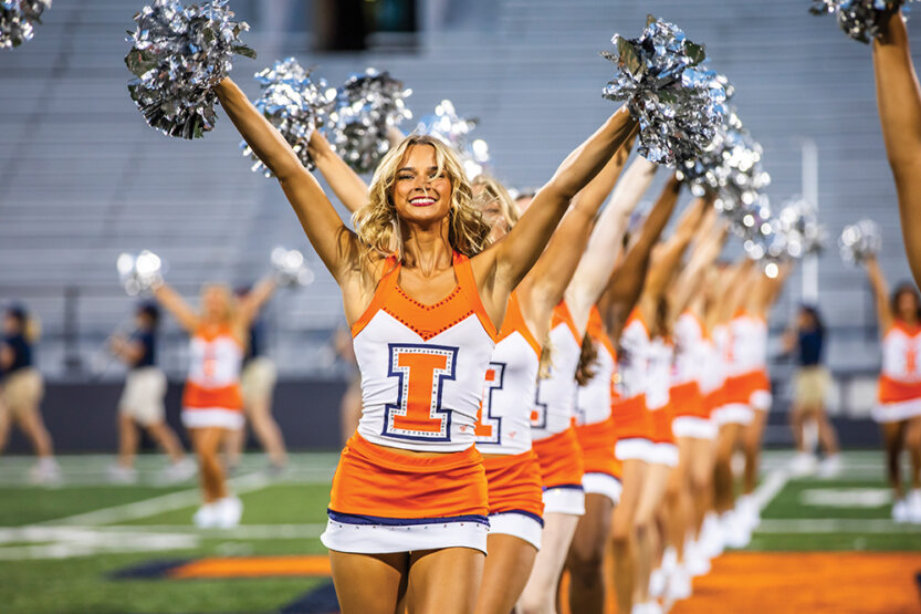 Cheerleaders performing on a football field