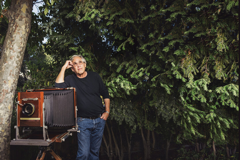 Doug Busch with his large format camera surrounded by trees