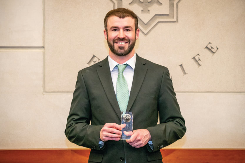 Colby Silvert holding an award