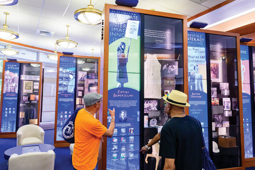 Three men looking an an exhibit