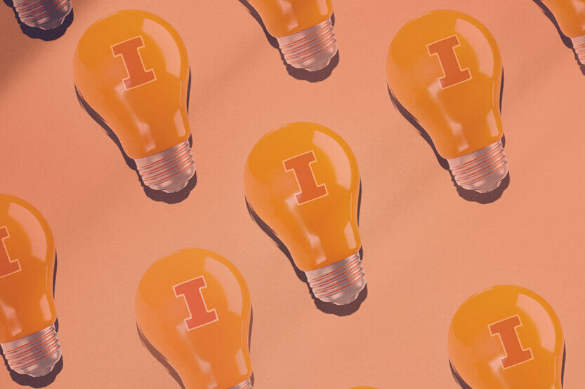 Lightbulbs with block I printed on them on orange pastel colored background
