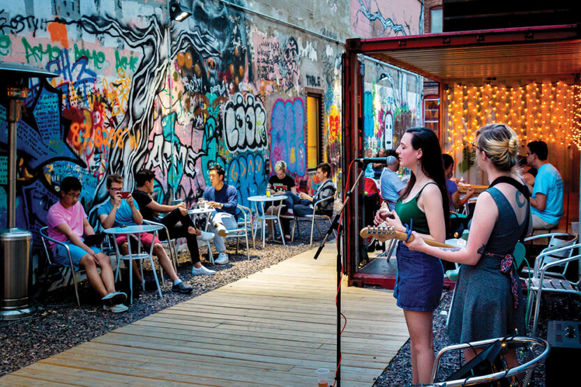 Female singers performing at a cozy outside bar