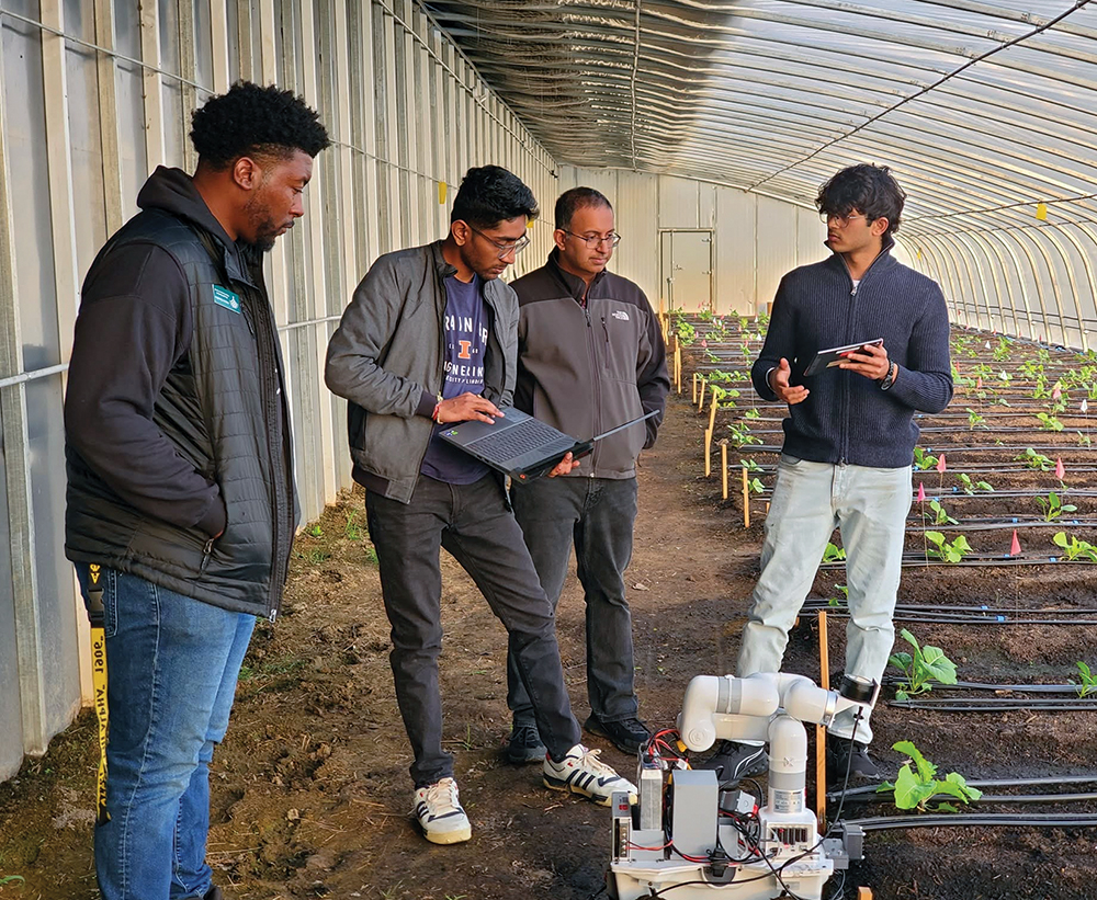 Men in greenhouse with laptop and scientific equipment